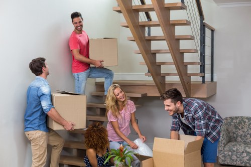 Staff member using safe lifting techniques during a move