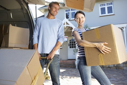 Packed moving boxes and furniture ready for collection in Dartford